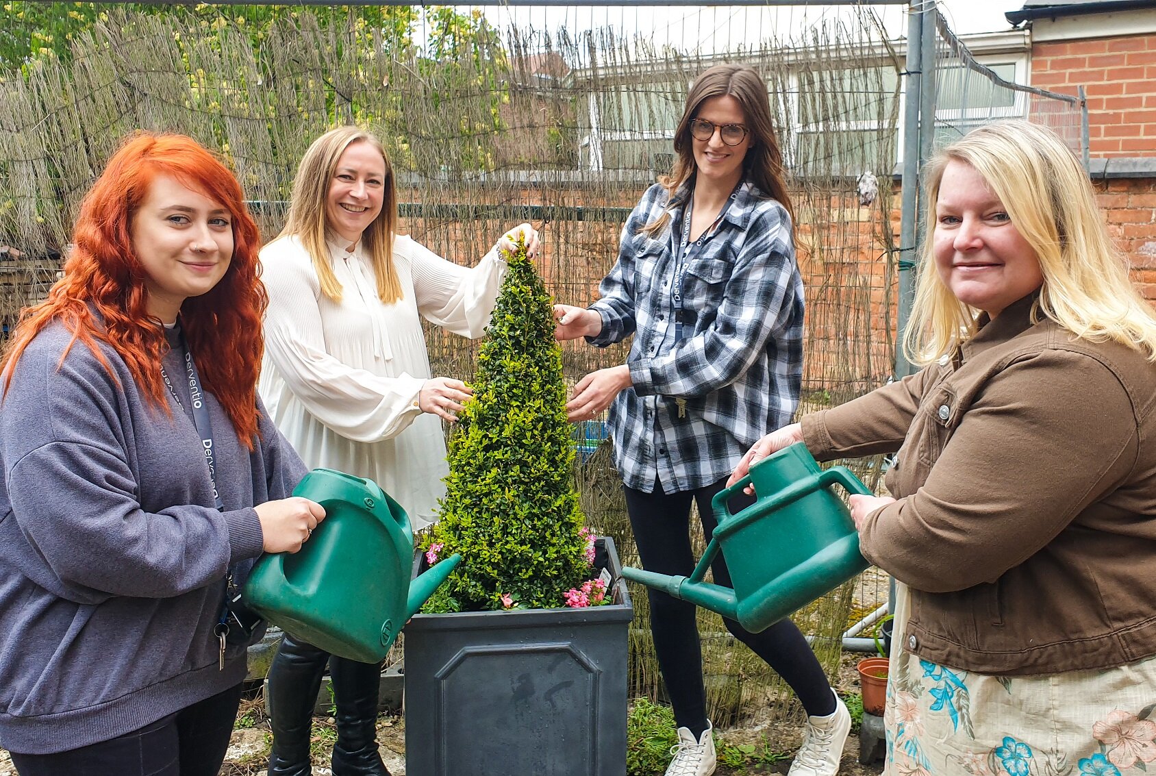 From left, Storm Taylor, a housing assistant at The Junction, Ceri Naylor, office manager at Gold Crest Surveyors, Emma Muir, team leader at The Junction, and Sharon Perry, head of client communications at Gold Crest Surveyors, with a planter that been donated to Derventio Housing Trust.