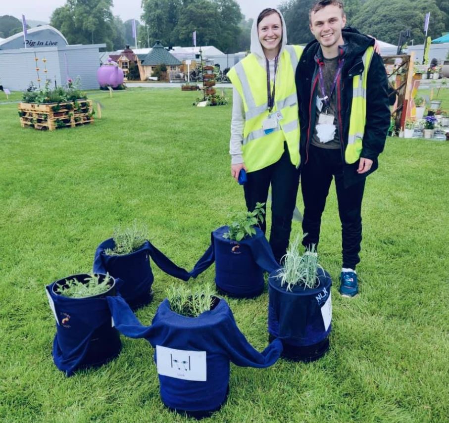 Anna Young and James Gough with the sensory planters made by pupils at St Giles School in Derby at the RHS Chatsworth Flower Show in Derbyshire. Penguin PR: public relations, media and communications