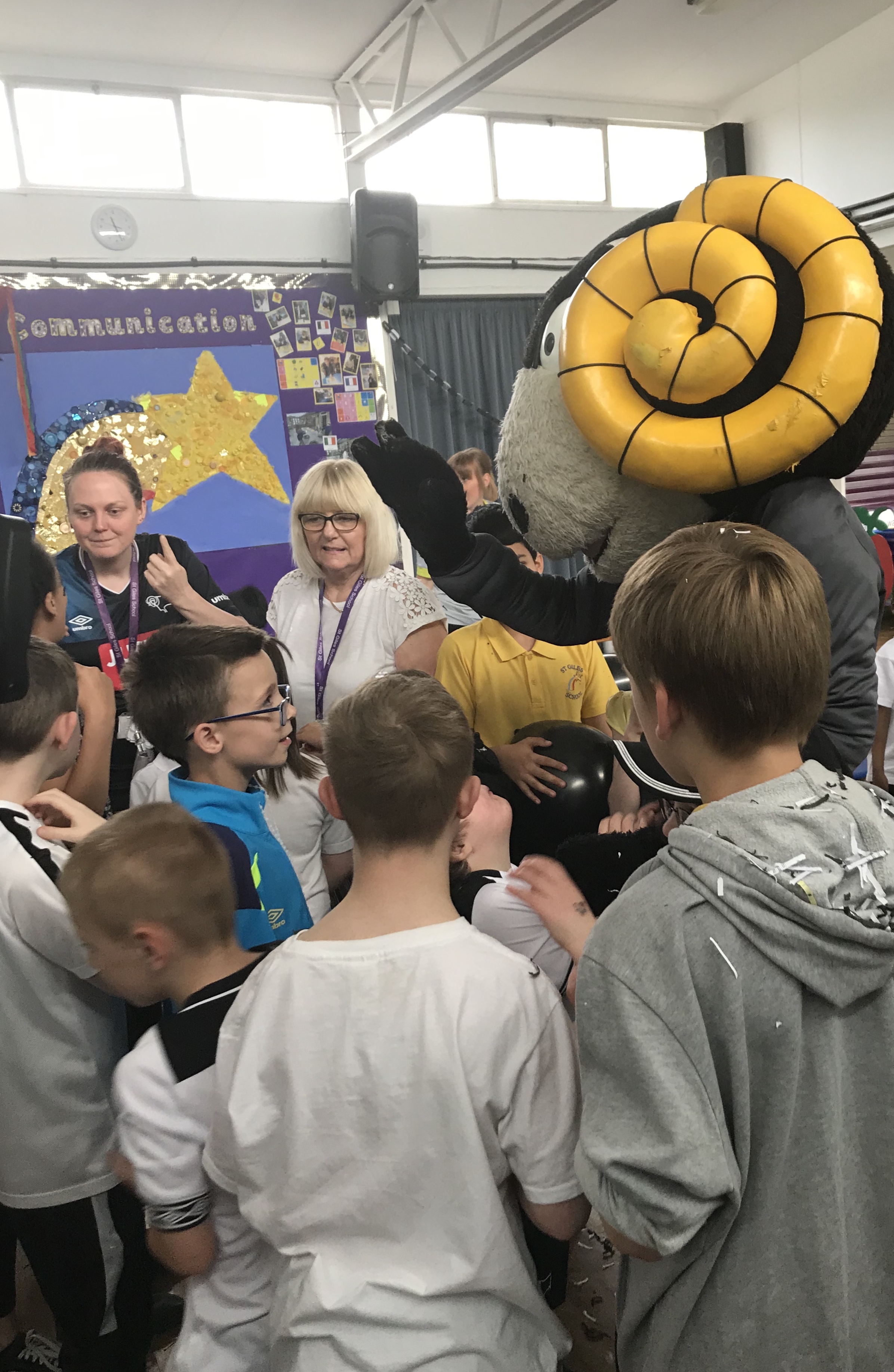 Derby County mascot Rammie was a special guest as staff and pupils from St Giles School performed Steve Bloomer's Watching using Makaton. Penguin PR: public relations, media and communications