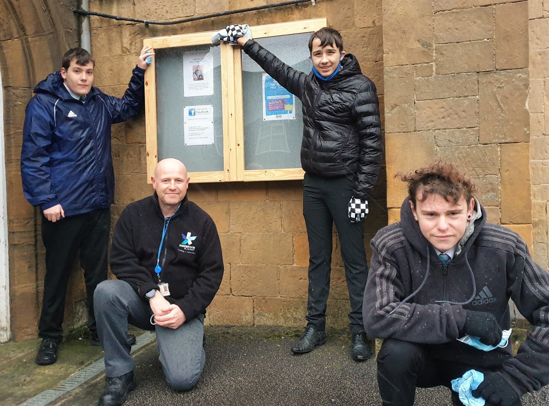 From left Thomas Bates, design and technology Simon Dosanjh, Nathan Buckingham and Ethan Poole with the new noticeboard they made for Holy Trinity Church in Shirebrook.&nbsp;