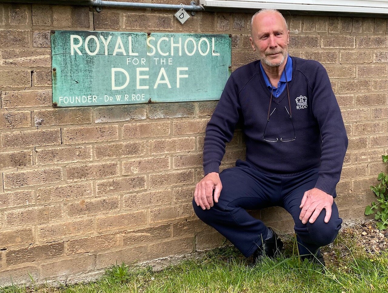 Bob Webb with Royal School for the Deaf sign.