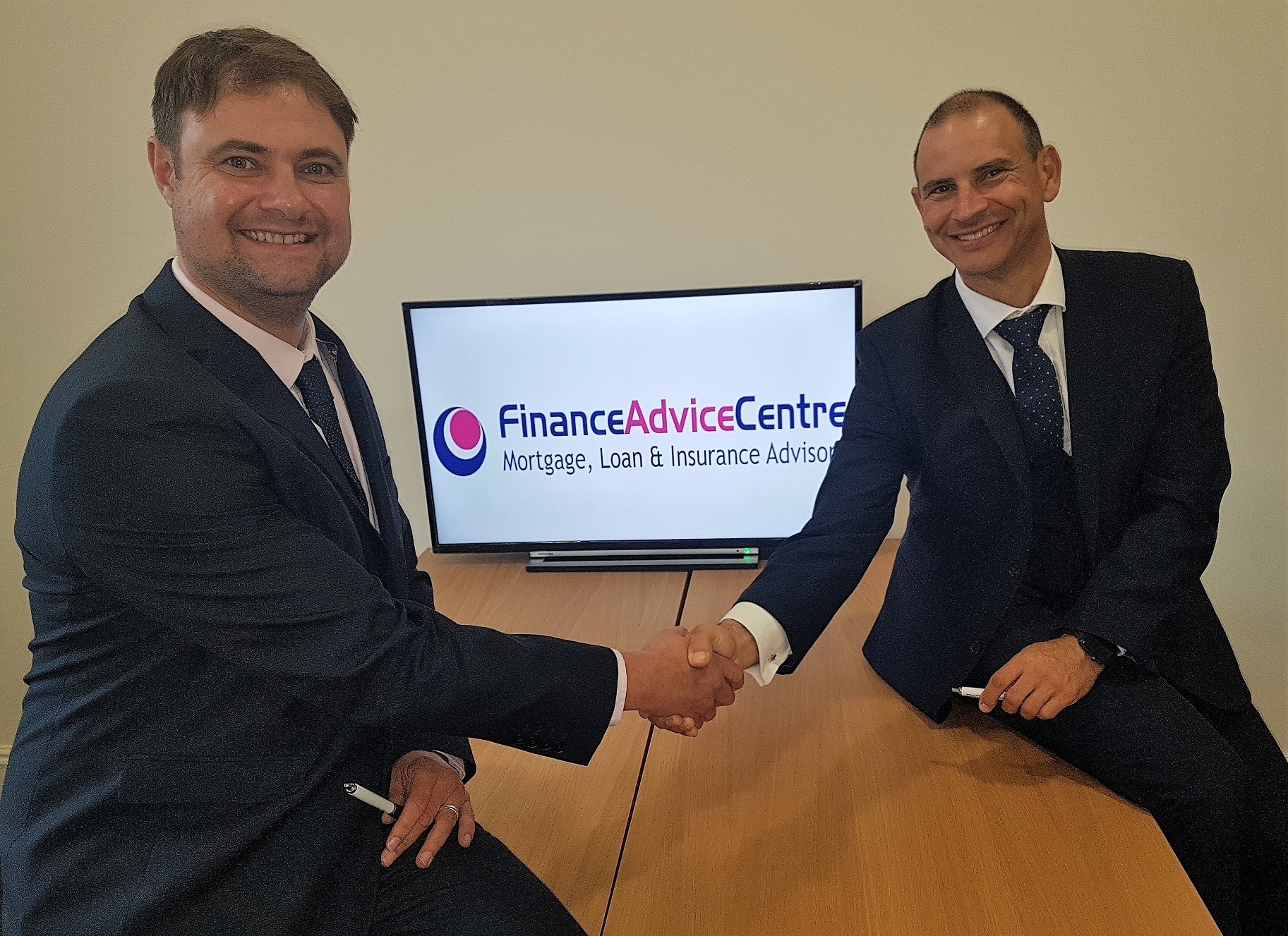 Picture shows: Dave Smit (left) shakes hands with Finance Advice Group’s managing director Matt Cassar following the launch of the company’s second Finance Advice Centre outlet in Ilkeston. Penguin PR: public relations, media and communications