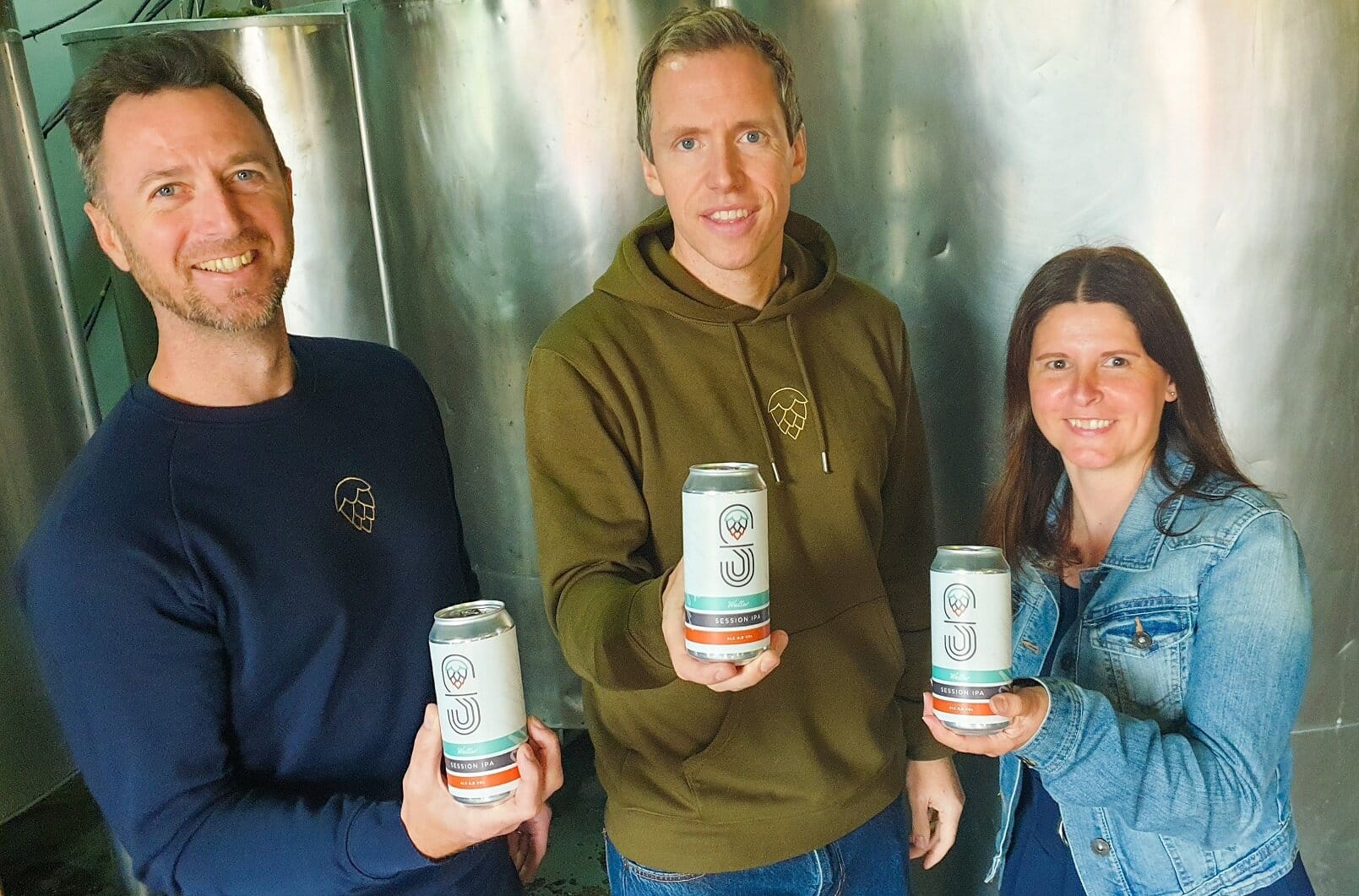 From left, fashion designer Karl Shaw from Derby’s Mr Shaw, Paul Harris, managing director of Derby Brewing Company and Karl’s wife, Emma Shaw, raise a can of Walter’s ale, which has been named after Emma’s dad, who died last year.