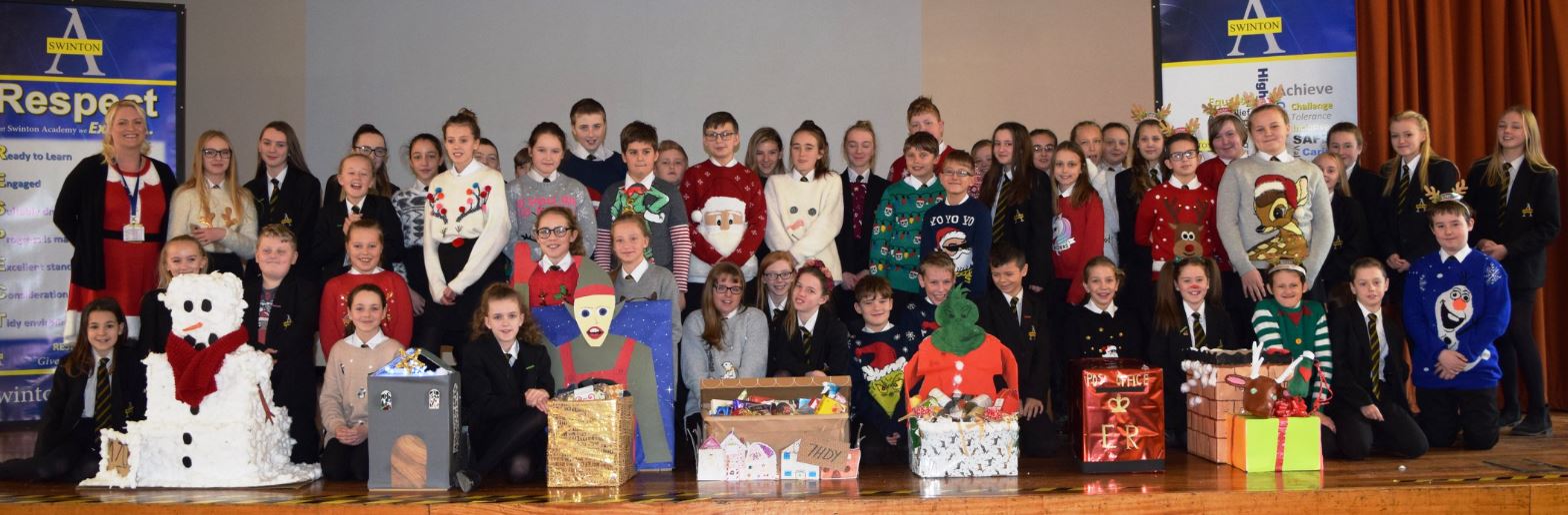 Year 7 pupils at Swinton Academy with their Christmas hampers, which will be distributed to local residents. Penguin PR: public relations, media and communications