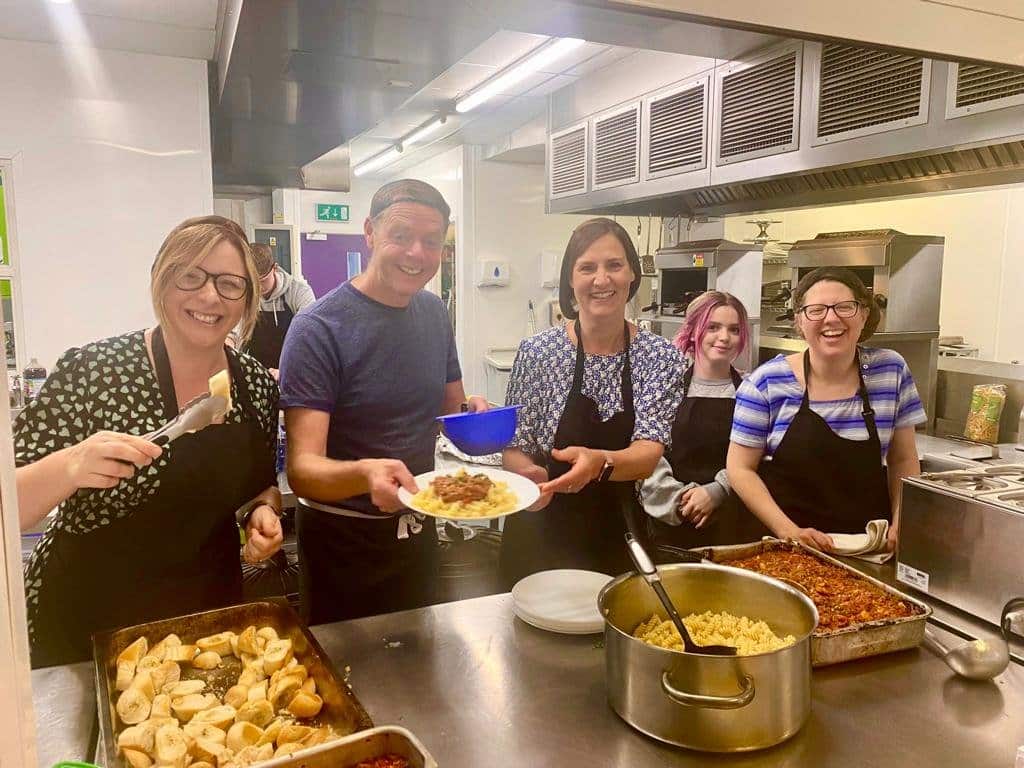 Penguin PR team serving up their meal at the YMCA