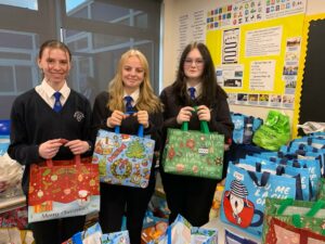 Murray Park Year 11 pupils Peyton Giles, Sophie Arnold and Erin MacPhail with the food parcels ready to be delivered