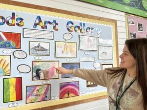 Tiegan Carter, Arts Lead at Oakwood Junior School, with work by pupils on display.