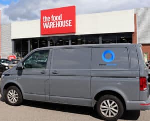 A grey van featuring the logo of Barron McCann is pictured outside a Food Warehouse store.