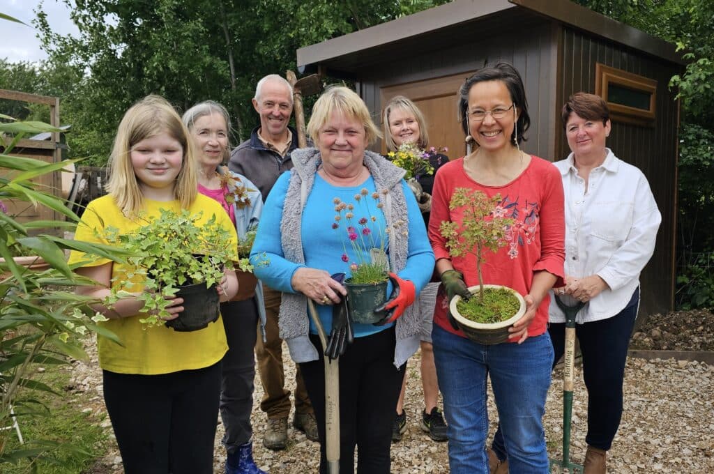 Forest Harvest founder Nick Burton and Sallyann Smith, co-founder of outdoor buildings firm Roundpeg Outdoor Buildings with members of the Community Bloom Group, which meets every week in Yoxall, near Burton.