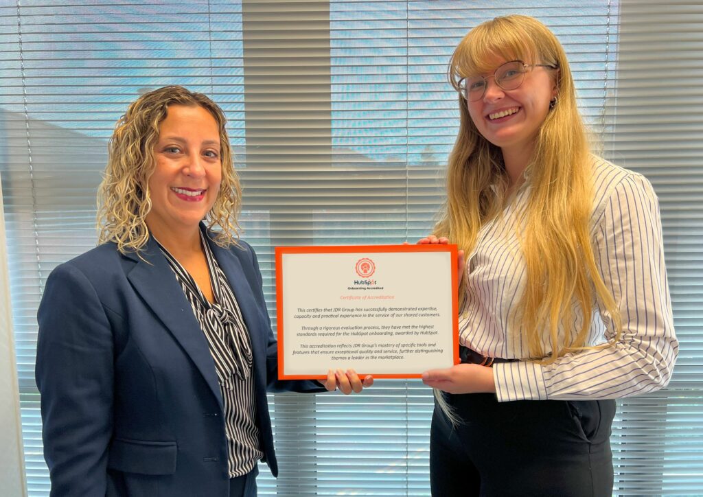 Leanne Mordue, left, a director at JDR Group, with the firm's senior campaign manager, Emma Ablewhite, and the company's onboarding accreditation status from Hubspot.