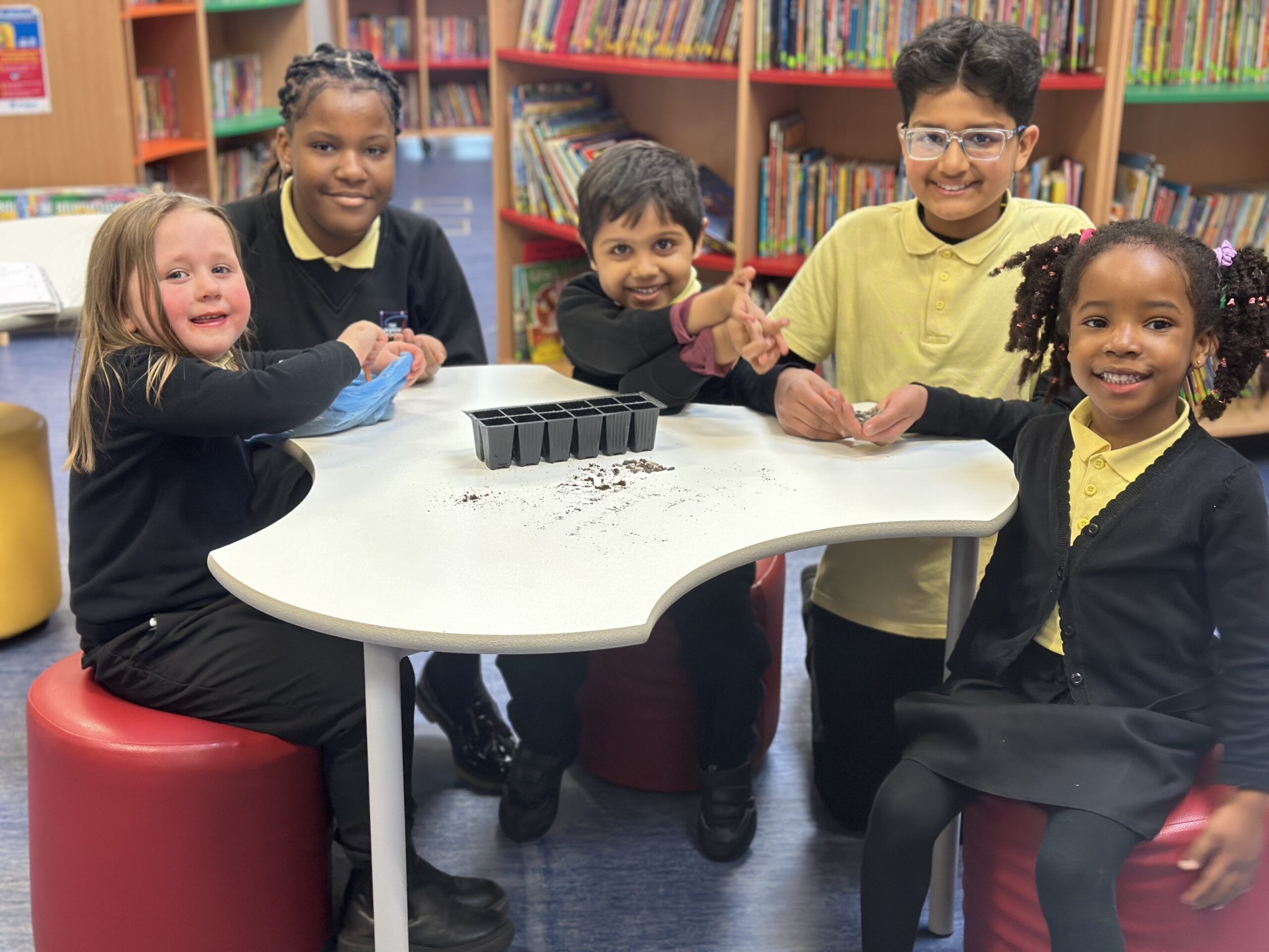 The Bemrose Schools mental health ambassadors supporting younger pupils with their sunflower planting