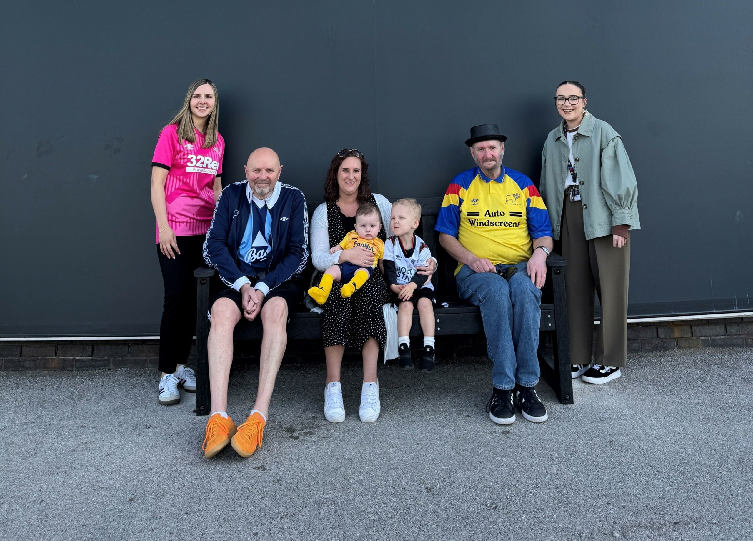 The Marson family on the TDP bench at Derby County Football Club with Kym Barlow from TDP, with nephew Finley and son Freddie, and Sophie Roddie from the club.
