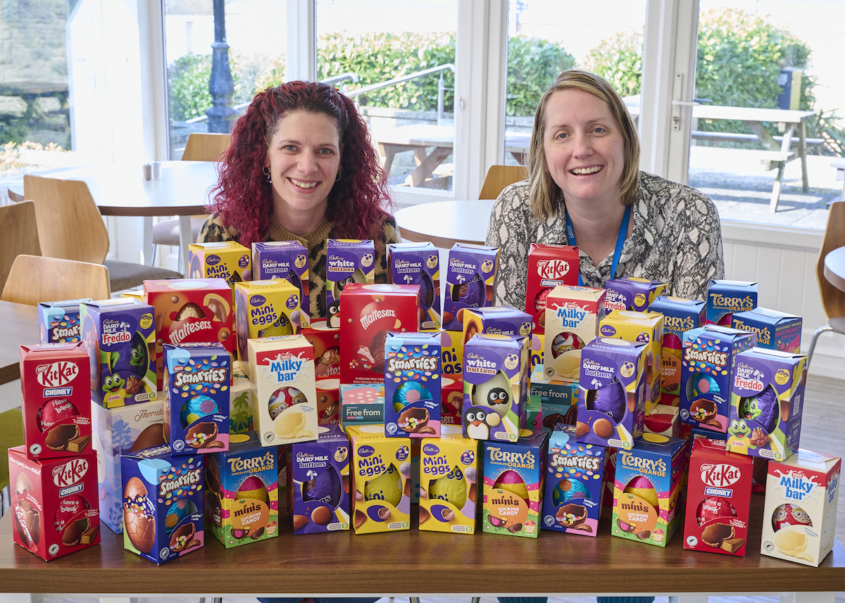 Claire Hollingshurst and Charlotte Hyman from Lubrizol with the pile of Easter eggs