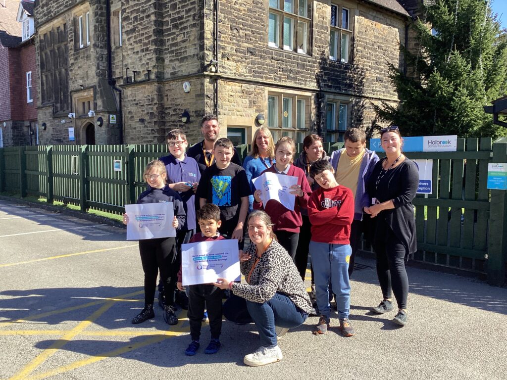 Sam Bayliss (back left) with pupils and staff from Holbrook School for Autism.