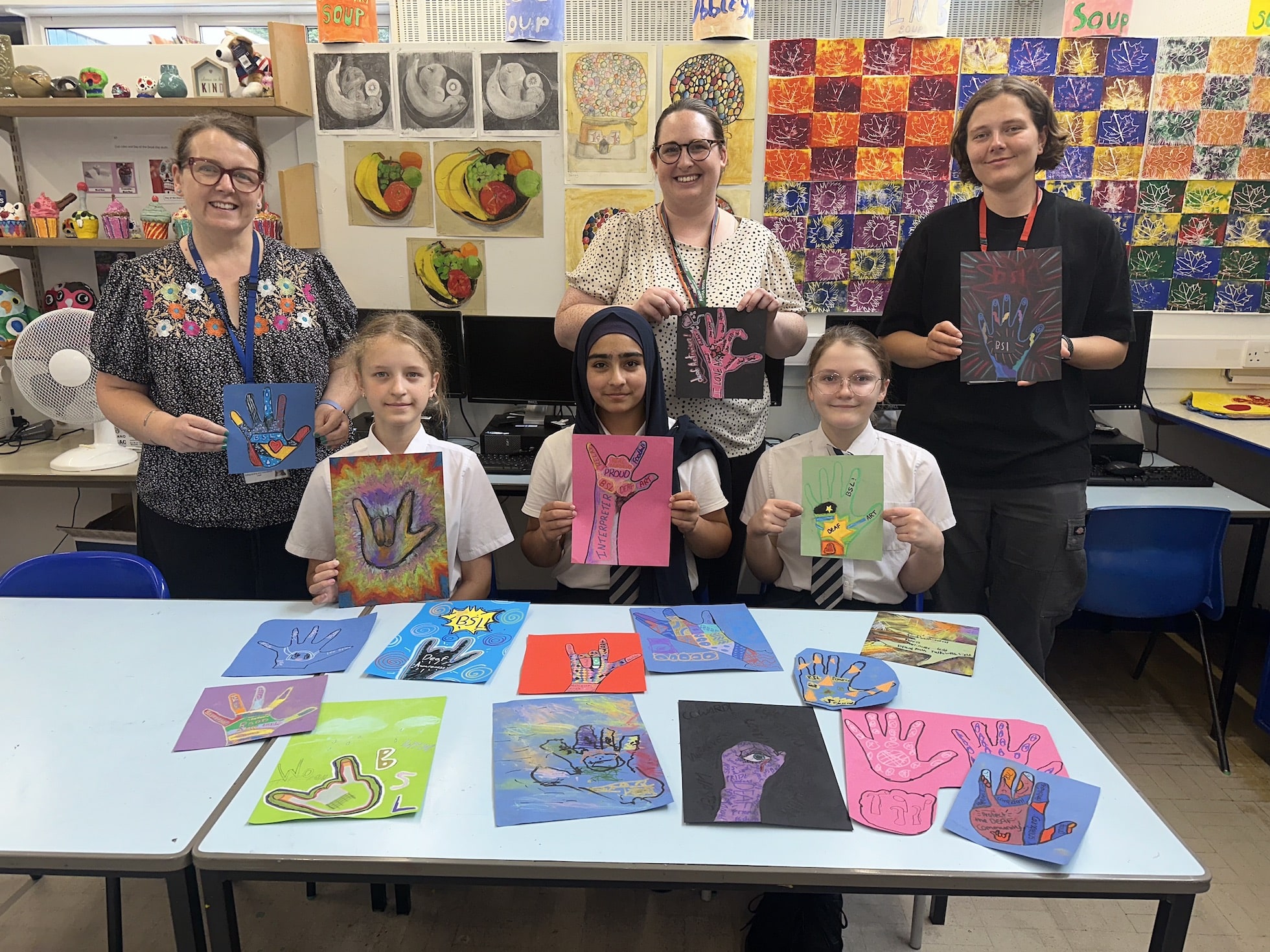 RSDD art teacher Lucy Noble, Natalie Smallwood from DANOP with Zoe Milner and pupils showing the artwork they created