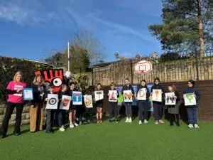 Children at William Gilbert Primary School given Outstanding status under the Modeshift travel scheme by Arry Cain and 'Strider' from Living Streets