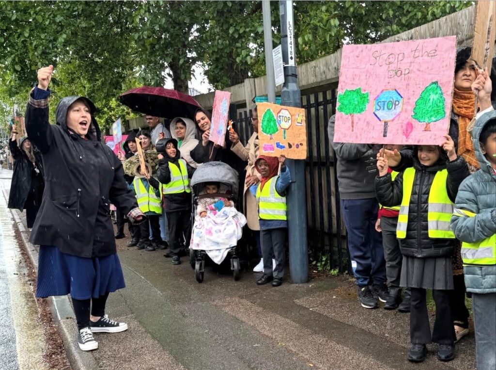 Waving placards and marching peacefully through the streets, pupils from a city infant school are leading an inspiring community campaign