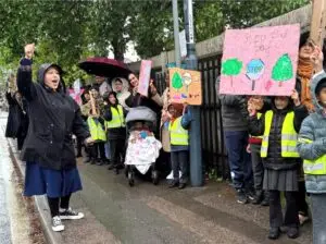 Waving placards and marching peacefully through the streets, pupils from a city infant school are leading an inspiring community campaign