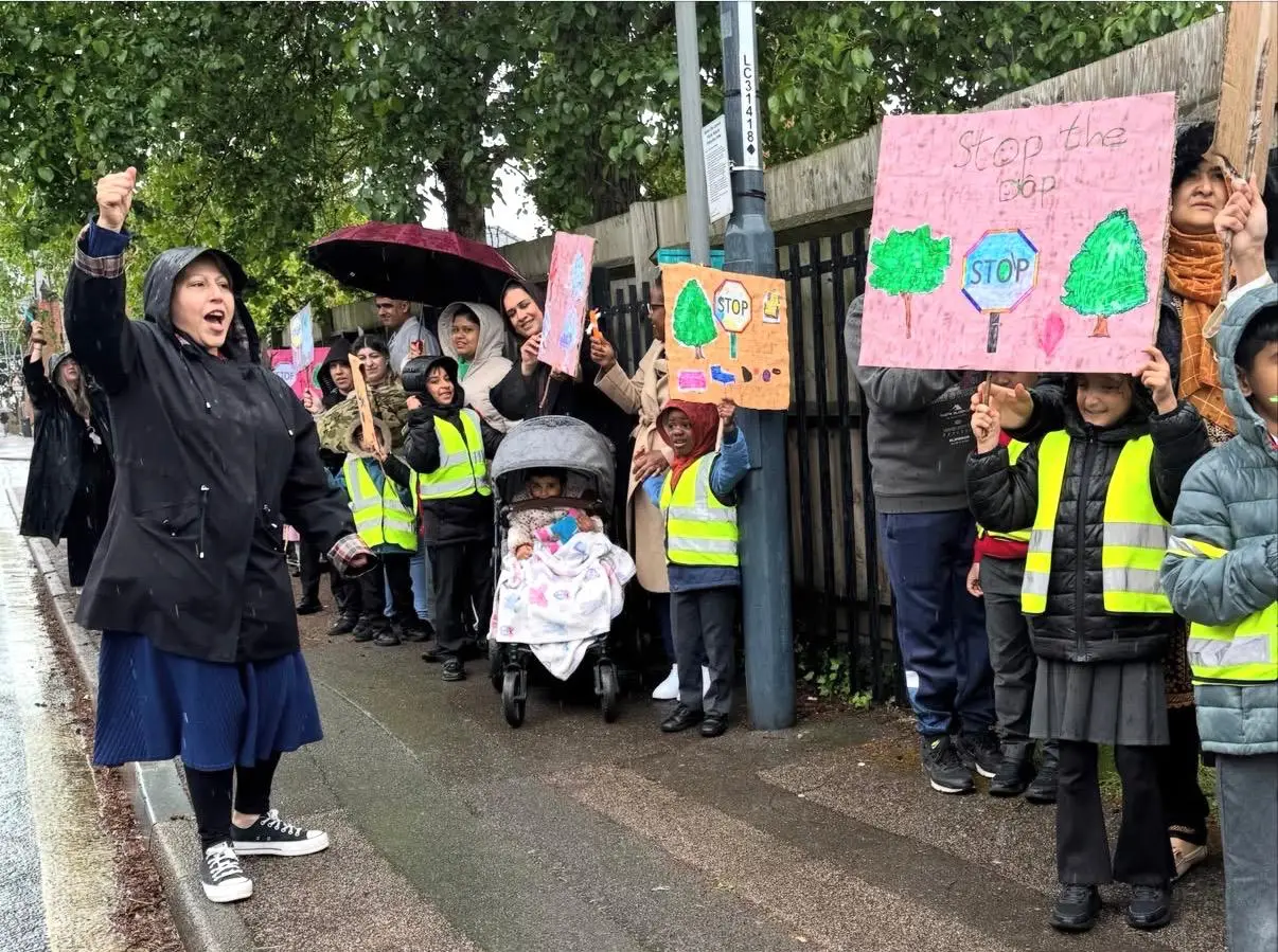Waving placards and marching peacefully through the streets, pupils from a city infant school are leading an inspiring community campaign