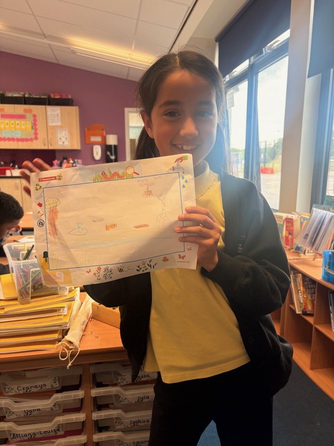 A pupil proud of her work during the celebration.