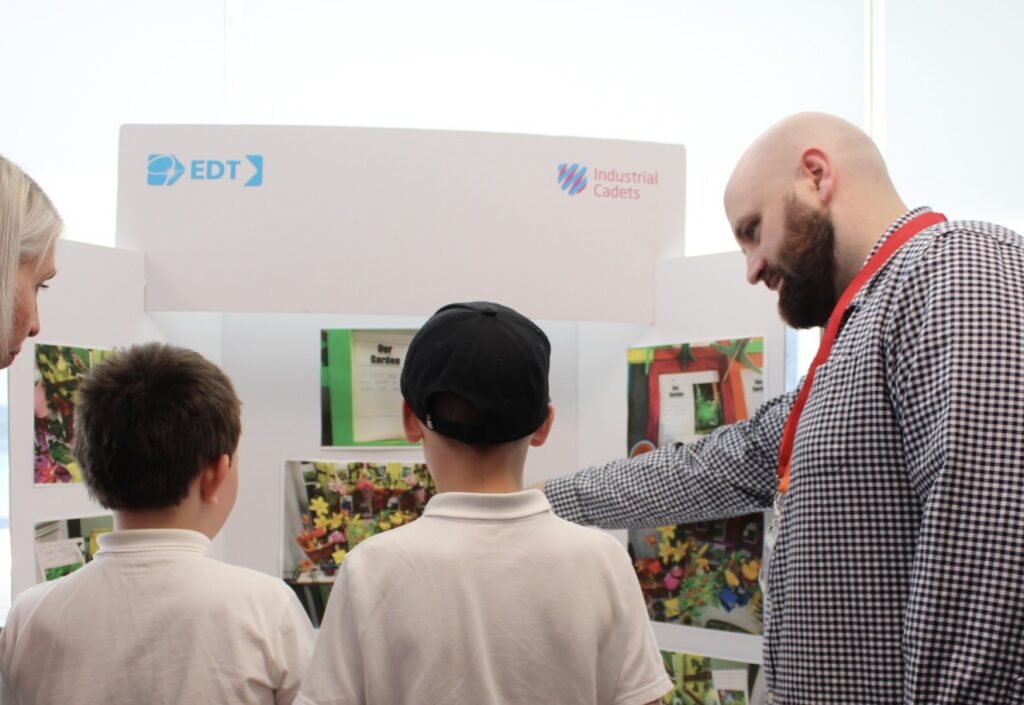 children and teaching staff looking at a careers board