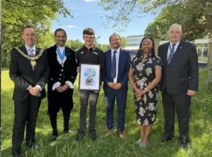 From left to right - Derby Mayor Jonathan Smale, Derby High Sheriff Syed Iftikhar, Caleb McDuff, RSDD head teacher Paul Burrows, Deputy Lieutenant Theresa Peltier and Chair of Governors at RSDD, David Muller.