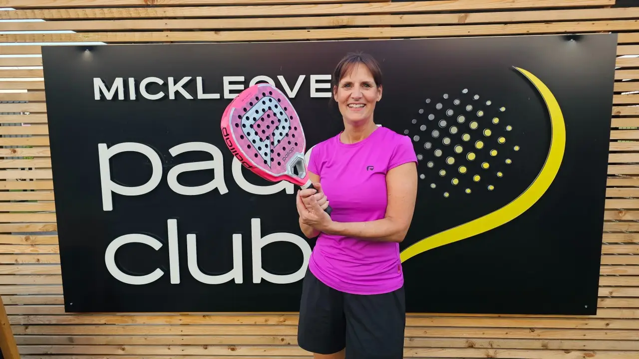 Sarah Newton holding a pink padel racket at the Mickleover Padel Club.